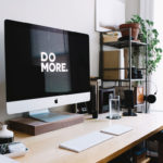 a computer that says do more on it on a desk