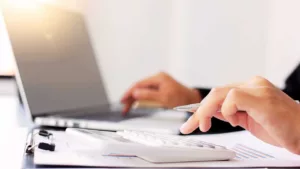 a person using a calculator for accounting