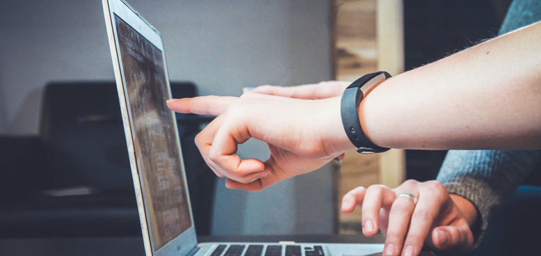 a person pointing at a computer screen