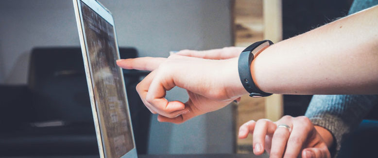 a person pointing at a computer screen